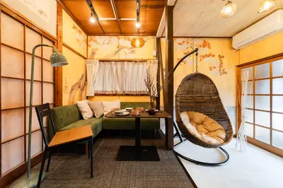 a room with a couch and a table and a chair at EDO GATEI Sakura Biyori Stay in Tokyo