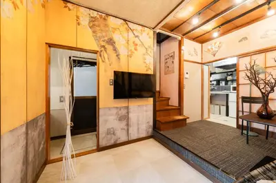 a living room with a tv on a wall at EDO GATEI Sakura Biyori Stay in Tokyo