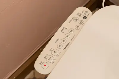 a white remote control sitting on top of a table at EDO GATEI Sakura Biyori Stay in Tokyo