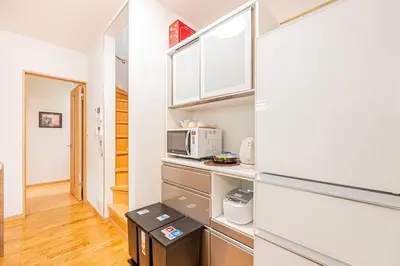 a kitchen with white cabinets and a microwave at Anzu 4 Bed rooms Villa 5 minutes walk from Keise line Edogawa station in Tokyo