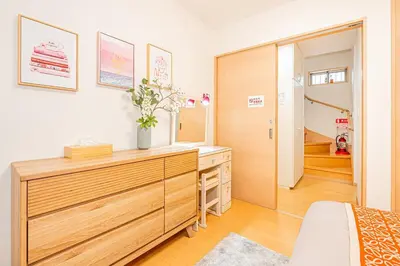 a bedroom with a wooden dresser and a mirror at Anzu 4 Bed rooms Villa 5 minutes walk from Keise line Edogawa station in Tokyo