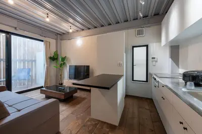 a kitchen and living room with a couch and a table at Funabori in Tokyo