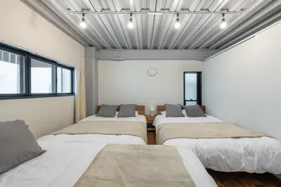 a room with four beds in it with windows at Funabori in Tokyo