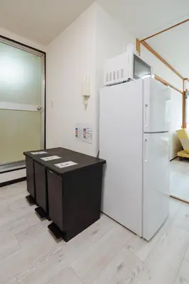 a room with a white refrigerator and a table at Solaria Tokiwa by Tranova in Tokyo