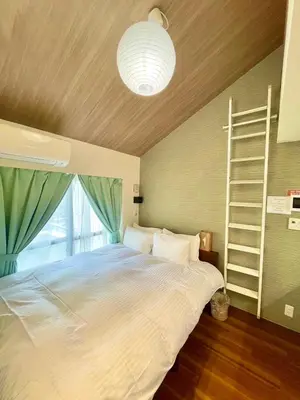 a bedroom with a large bed with a large window at fukuhana \u6771\u65b0\u5bbf C8 in Tokyo