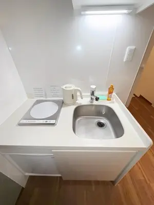 a sink in a room with a white counter at fukuhana \u6771\u65b0\u5bbf C8 in Tokyo
