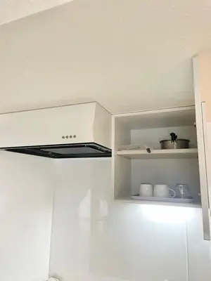 a white stove top oven in a white kitchen at fukuhana \u6771\u65b0\u5bbf C8 in Tokyo