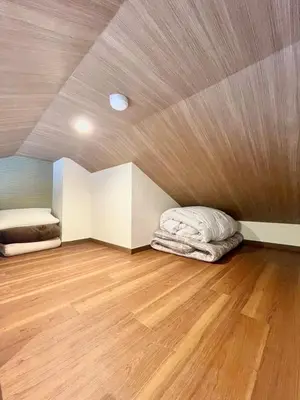 a room with two beds and a wooden floor at fukuhana \u6771\u65b0\u5bbf C8 in Tokyo