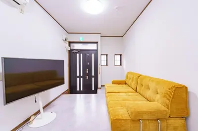 a living room with a couch and a flat screen tv at Konoha Sangenjaya DZ4 in Tokyo