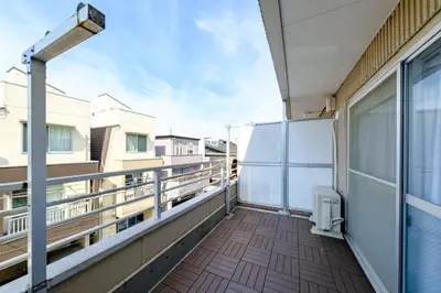 a balcony with a view of a building at Living Stay Plum Residence - Authentic Tokyo Stay - Direct to HND 20m & Shinagawa in Tokyo