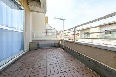 an empty balcony of a building with a large window at Living Stay Plum Residence - Authentic Tokyo Stay - Direct to HND 20m & Shinagawa in Tokyo
