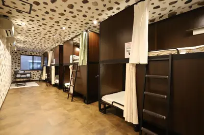 a row of bunk beds in a dorm room at \u30e9\u30dd\u30fc\u30eb\u6771\u5411\u5cf6 in Tokyo