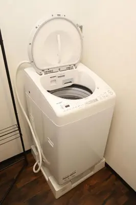 a white toilet with the lid up in a room at \u30e9\u30dd\u30fc\u30eb\u6771\u5411\u5cf6 in Tokyo