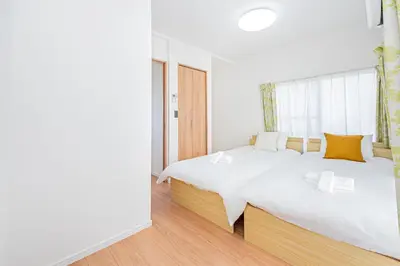 a white bedroom with a large bed and a window at Mori house \u65b0\u5c0f\u5ca9B in Tokyo