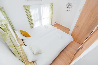 a small bedroom with a white bed and a window at Mori house \u65b0\u5c0f\u5ca9B in Tokyo