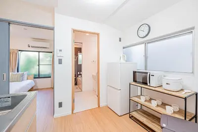 a kitchen with a refrigerator and a microwave at Mori house \u65b0\u5c0f\u5ca9B in Tokyo