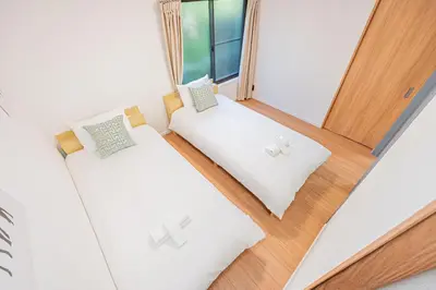 two beds in a room with a window at Mori house \u65b0\u5c0f\u5ca9B in Tokyo