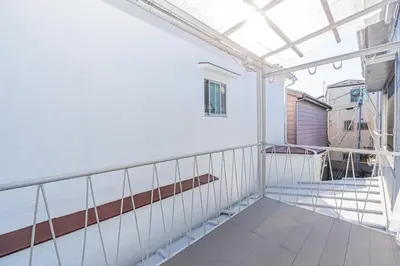 a balcony with awning and stairs in a building at Mori house \u65b0\u5c0f\u5ca9B in Tokyo