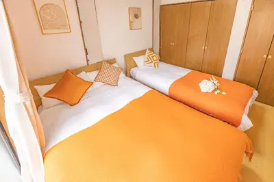 two beds sitting next to each other in a room at 3 Story Private House, 7 Min Walk to Yamanote Line Direct to Shinjuku, Ikebukuro, Shibuya in Tokyo