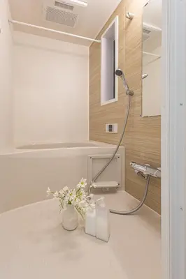 a bathroom with a shower with a vase of flowers at 3 Story Private House, 7 Min Walk to Yamanote Line Direct to Shinjuku, Ikebukuro, Shibuya in Tokyo