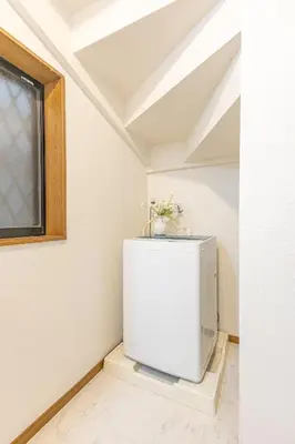 a small white refrigerator in a room with a window at 3 Story Private House, 7 Min Walk to Yamanote Line Direct to Shinjuku, Ikebukuro, Shibuya in Tokyo