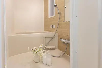 a bathroom with a shower with a vase of flowers at 3 Story Private House, 7 Min Walk to Yamanote Line Direct to Shinjuku, Ikebukuro, Shibuya in Tokyo