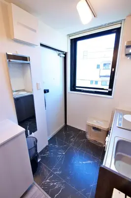 a small kitchen with a sink and a window at TOMALCO INN NAKANO 2 3F Flat 2 Bath 13 min to Shinjuku from Honancho in Tokyo