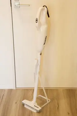 a white hairdryer sitting on the floor next to a door at TOMALCO INN NAKANO 2 3F Flat 2 Bath 13 min to Shinjuku from Honancho in Tokyo