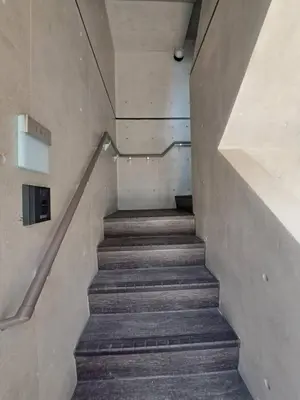 a staircase in a building with a stair case at TOMALCO INN NAKANO 2 3F Flat 2 Bath 13 min to Shinjuku from Honancho in Tokyo