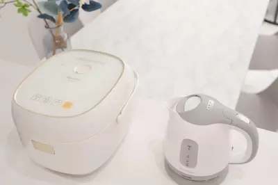 a wii remote control next to a vase on a table at Brand New Luxury Suite 7 min to Omotesando 2 min to Shibuya in Tokyo