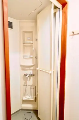a small white refrigerator in a small room at Shinjuku Y HOTEL II 1 minute to 7-Eleven 6DK 2 bathrooms in Tokyo