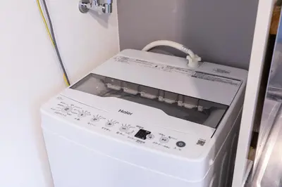 a white washer and dryer in a small room at iroha in Tokyo
