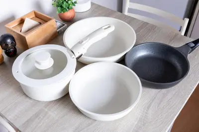 a counter with white bowls and a frying pan on it at iroha in Tokyo