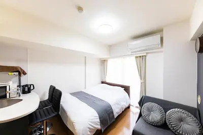 a bedroom with a bed and a desk and a sink at \u7acb\u5730\u6700\u9ad8 \u65b0\u5bbf\u6b4c\u821e\u4f0e\u753a \u65b0\u5bbf\u99c5\u5f92\u6b69\u570f\u5185 \u6700\u59273\u540d\u69d8\u307e\u3067\u5bbf\u6cca\u53ef\u80fd 6\u8def\u7dda\u5229\u7528\u53ef\u80fd 6\u6b73\u4ee5\u4e0b\u306f\u7121\u6599\u3067\u3059 in Tokyo