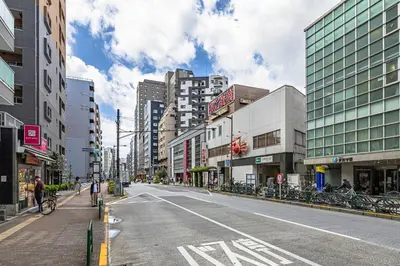 an empty street in a city with tall buildings at \u65b0\u5bbfClassy House in Tokyo