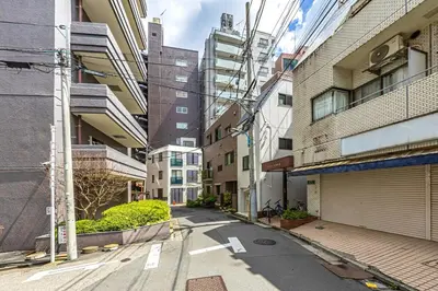an empty street in a city with tall buildings at \u65b0\u5bbfClassy House in Tokyo