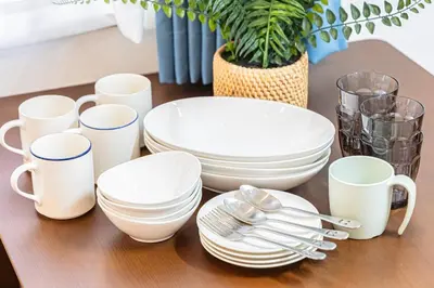 a table with white plates and utensils on it at \u65b0\u5bbfClassy House in Tokyo