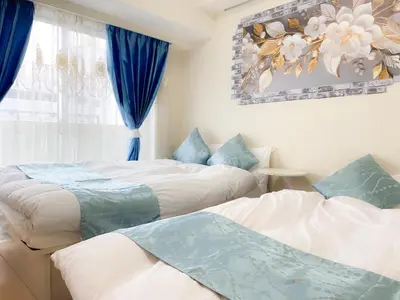 two beds in a room with blue curtains at 901 5mins from JR Kinshicho! Near Asakusa&Skytree! in Tokyo