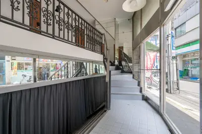a hallway of a building with stairs and windows at Sharil Shiina-machi in Tokyo