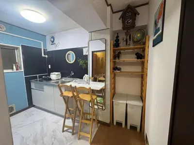 a small kitchen with a table and chairs in a room at \u548c\u98a82\u897f\u5317\u53e3 in Tokyo