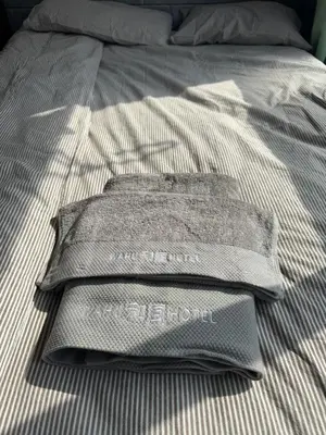 a gray shirt is sitting on a bed at \u548c\u98a82\u897f\u5317\u53e3 in Tokyo
