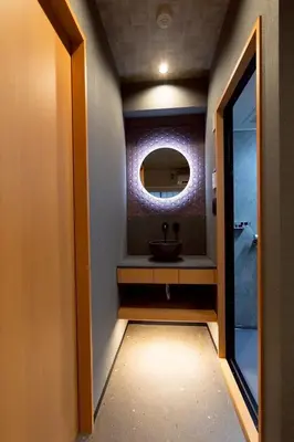 a bathroom with a sink and a mirror at Hotel Matsunoi Shurin in Tokyo