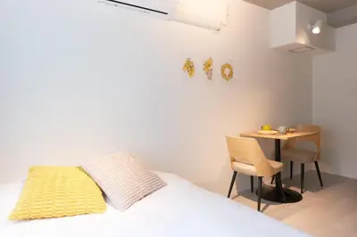 a bedroom with a bed and a small table at Bellie Sangenjaya by Tranova in Tokyo