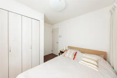 a white bedroom with a bed and a white cabinet at \u5c0f\u6797 home in Tokyo