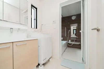 a white bathroom with a sink and a shower at \u5c0f\u6797 home in Tokyo