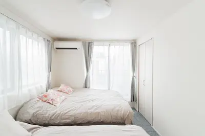 a bedroom with a bed and a large window at \u5c0f\u6797 home in Tokyo