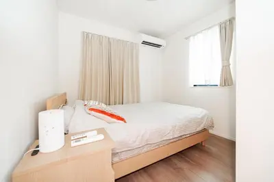 a bedroom with a bed and a desk and a window at \u5c0f\u6797 home in Tokyo