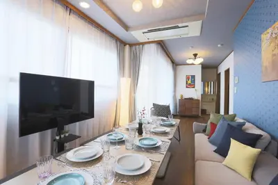 a living room with a table and a television at Stay Master Hotel in Tokyo