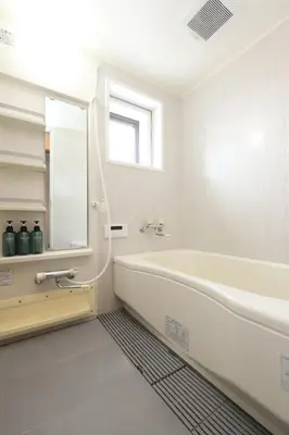 a white bathroom with a tub and a window at Stay Master Hotel in Tokyo