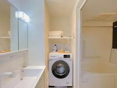 a bathroom with a washing machine and a washer at Sakura Stay \u5343\u99c4\u6728 in Tokyo